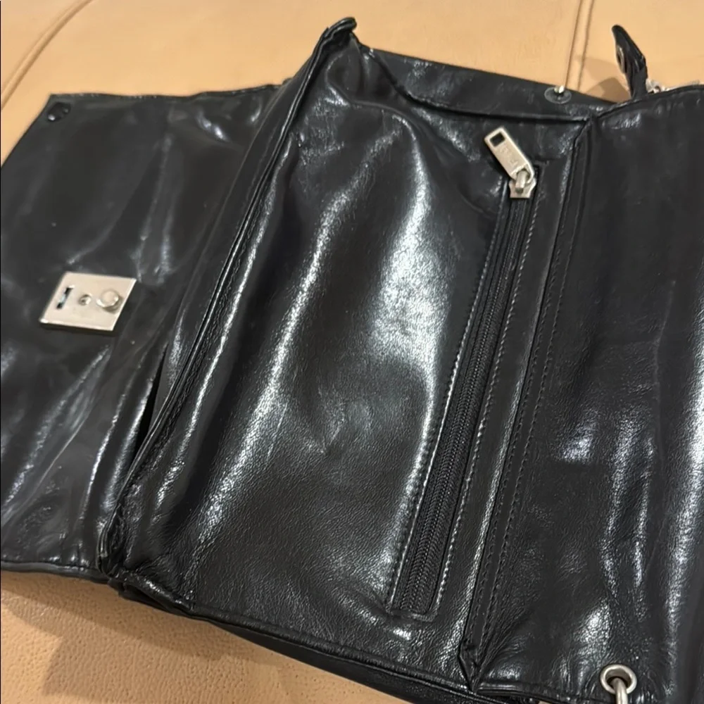Black Messenger Bag with Sleek Design and Metallic Hardware